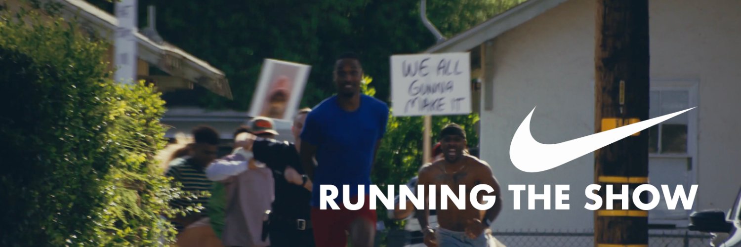 Runners racing down a street with the Nike swoosh and the words Running the Show